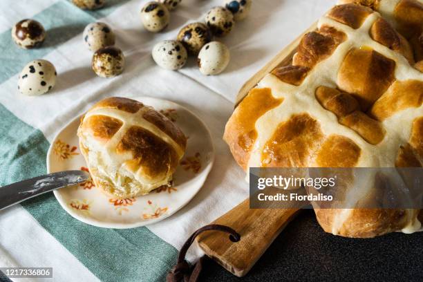 easter homemade hot cross buns, buttered with butter - hot cross buns stock-fotos und bilder