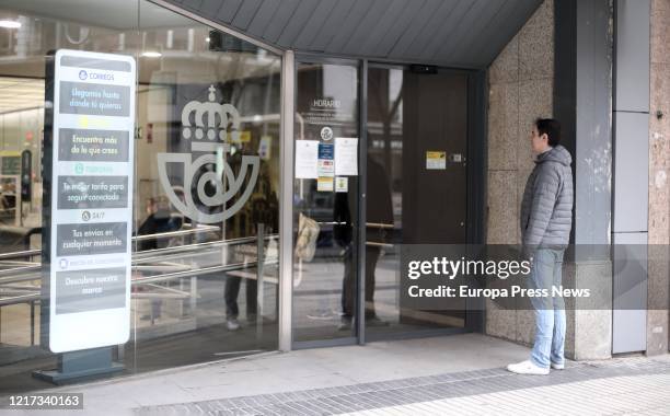 Man waits for his turn in front of one of the post offices where Correos company is distributing, through their network of offices, almost a million...