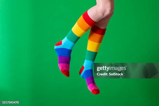 jumping for joy - striped socks stock pictures, royalty-free photos & images