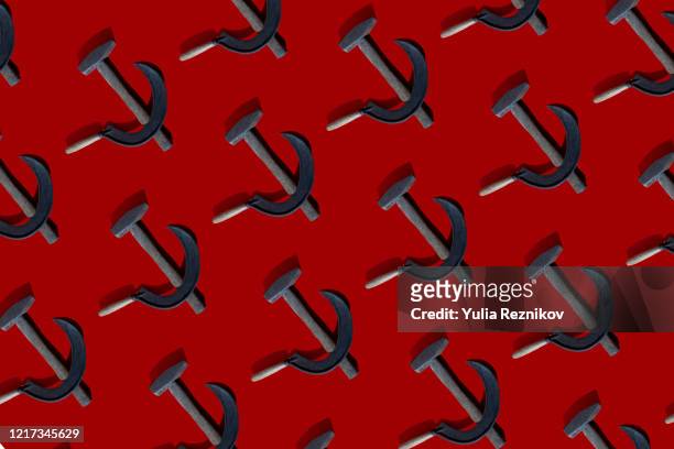 sickle and hammer on the red background - russia sanctions stock-fotos und bilder