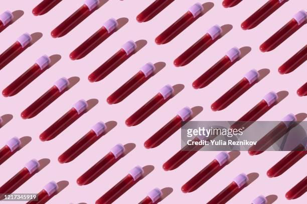 covid-19 test tubes on the pink background - blood stock pictures, royalty-free photos & images