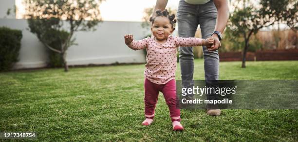 look who's walking! - baby girls stock pictures, royalty-free photos & images