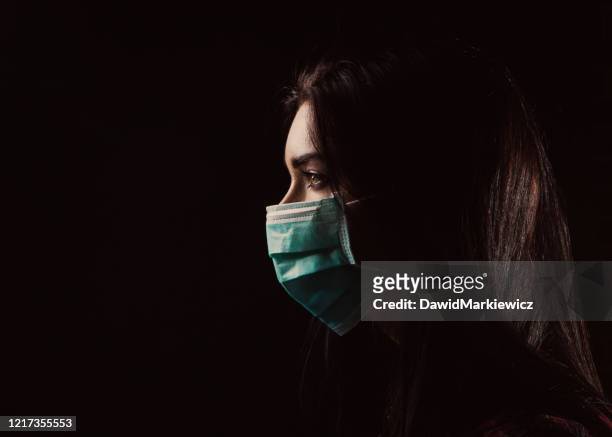 beautiful woman in a blue mask - pandemic illness stock pictures, royalty-free photos & images