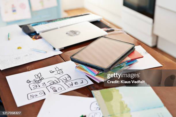 digital tablet and homework on dining table - textbook stack stock pictures, royalty-free photos & images