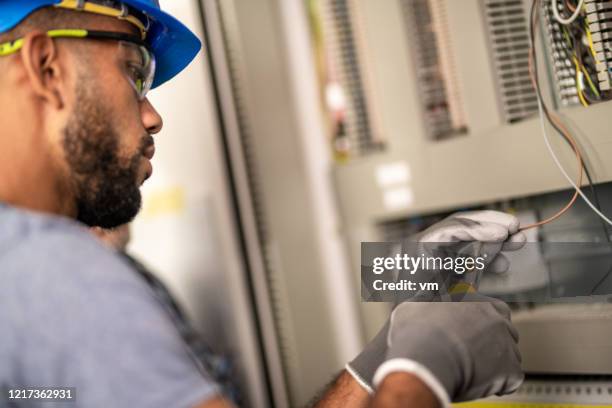 african-american electrician stripping a wire - electrician working stock pictures, royalty-free photos & images