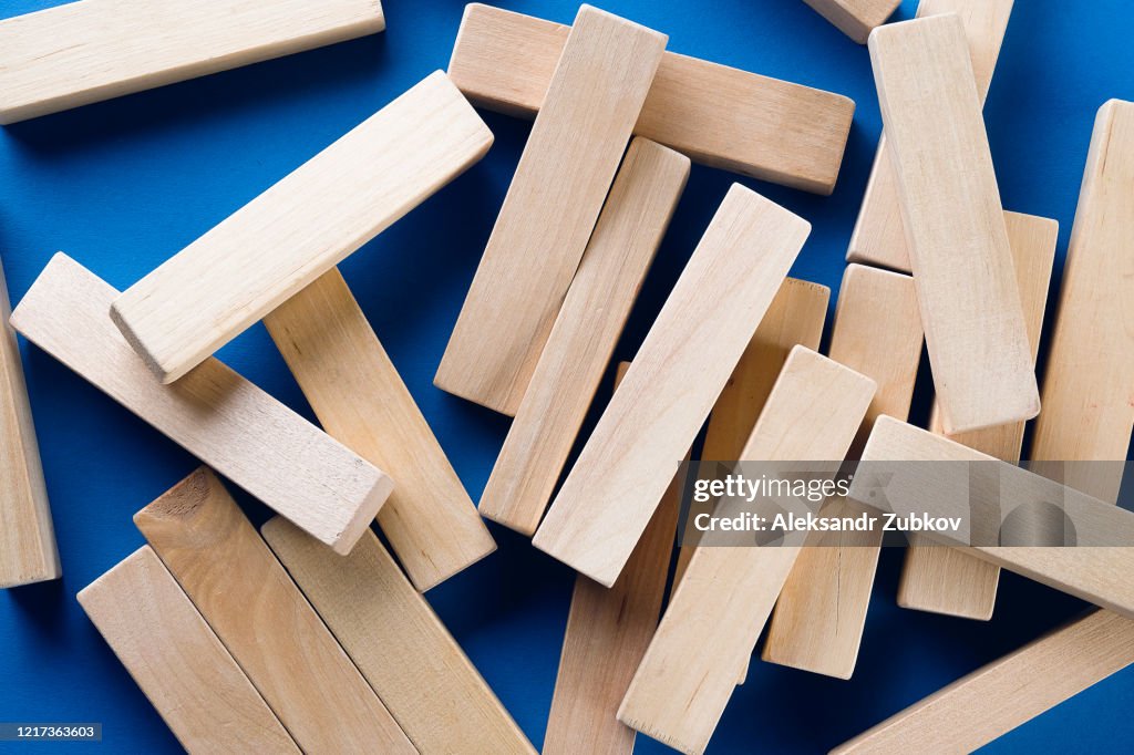 Blocks Scatered A Pile Of Scattered Wooden Blocks On A Blue Background Construction ...