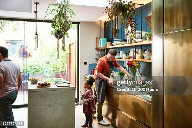 father preparing meal with young girl in stylish kitchen - design kitchen stock pictures, royalty-free photos & images