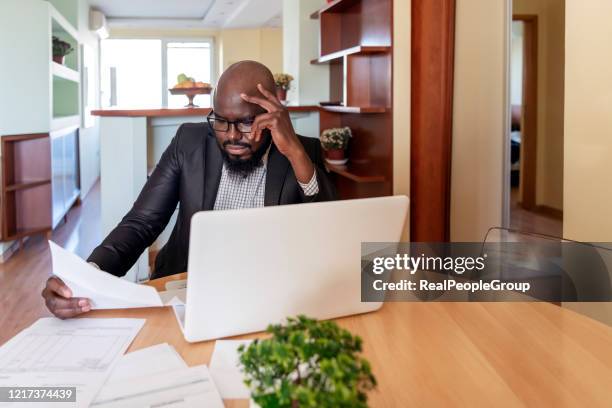 portrait of african man reads negative document. bank notice, bankruptcy, loss of a loved one. bad unexpected news in postal mail letter, male disappointed by post correspondence, bank debt or eviction notice. - information sign stock pictures, royalty-free photos & images