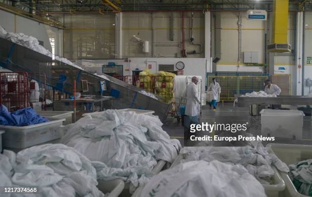 Workers during the washing process at Ilunion Lavanderia, a company within the ONCE social group, specialized in washing and treating hospital and...