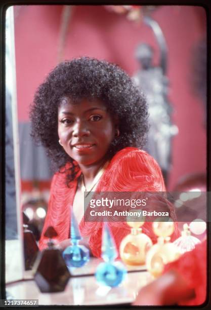 Portrait of American Disco and R&B singer Gloria Gaynor as she poses, reflected in a mirror, 1981.
