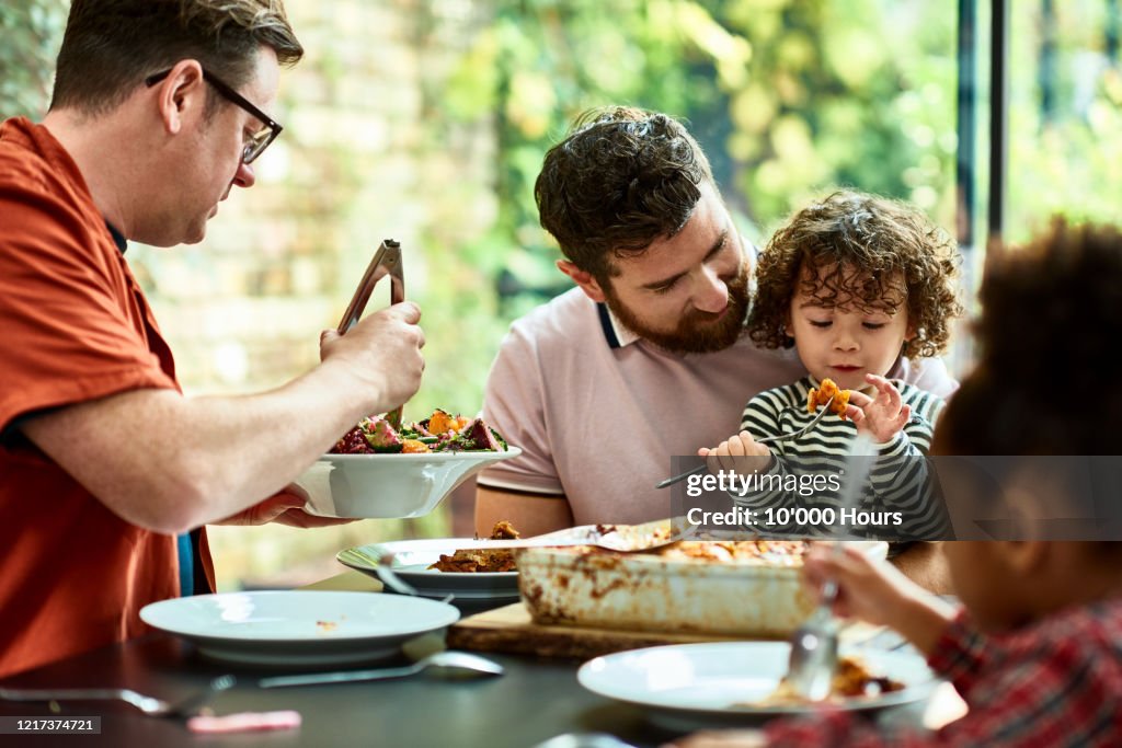 New family enjoying vegetarian lunch together during lockdown