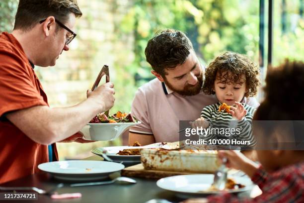 new family enjoying vegetarian lunch together during lockdown - comfort food stock pictures, royalty-free photos & images