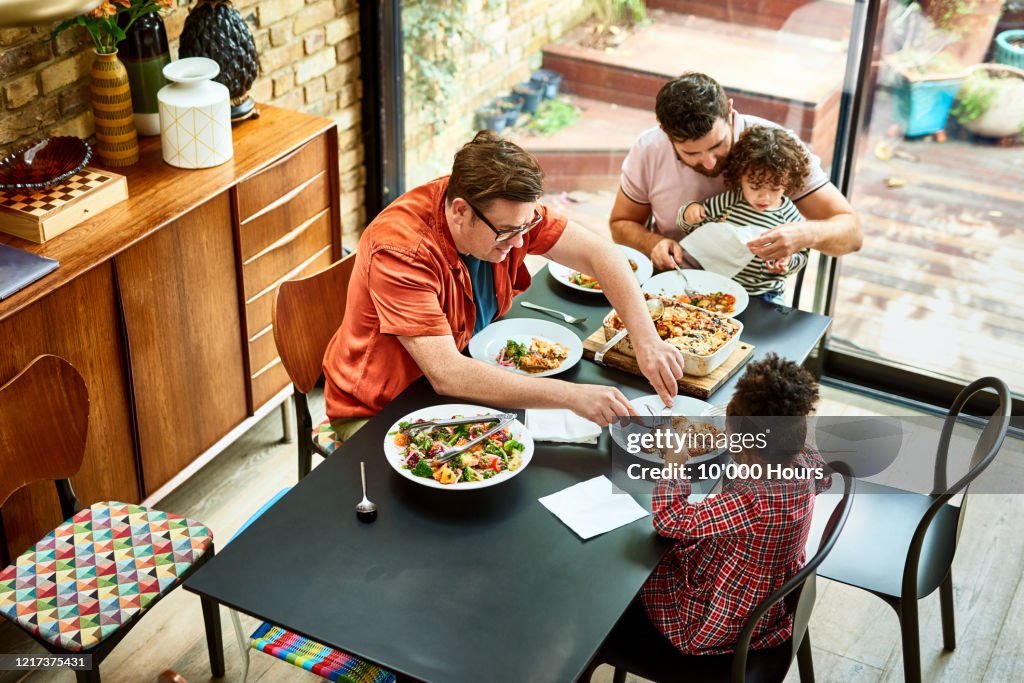 Modern family enjoying vegetarian food together during lockdown