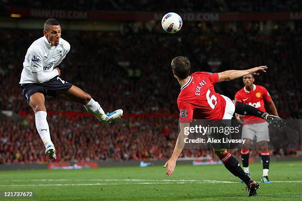 Jake Livermore of Tottenham Hotspur attempts to block the kick by Jonny Evans of Manchester United during the Barclays Premier League match between...