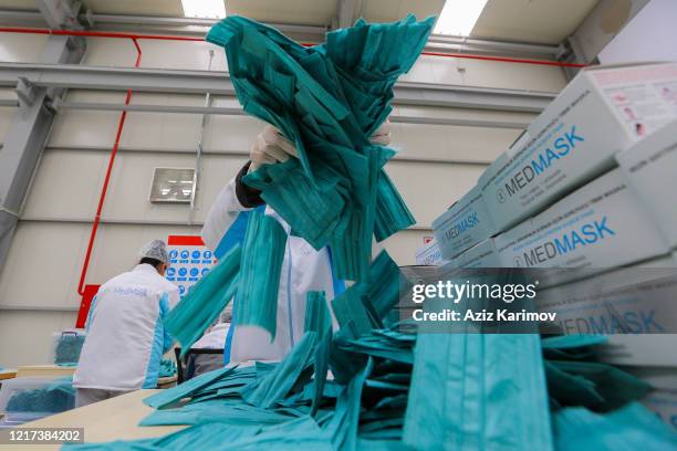 Workers produce face masks at "Baku Textile Factory" company at Sumgait Chemical Industrial Park on April 7, 2020 in Baku, Azerbaijan. The...