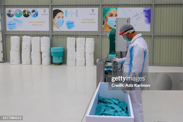 Workers produce face masks at "Baku Textile Factory" company at Sumgait Chemical Industrial Park on April 7, 2020 in Baku, Azerbaijan. The...