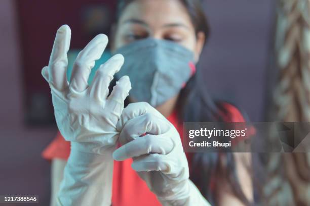 the girl is protecting herself from gloves and stay home. self quarantine. covid-19 pandemic. - covid india stock pictures, royalty-free photos & images