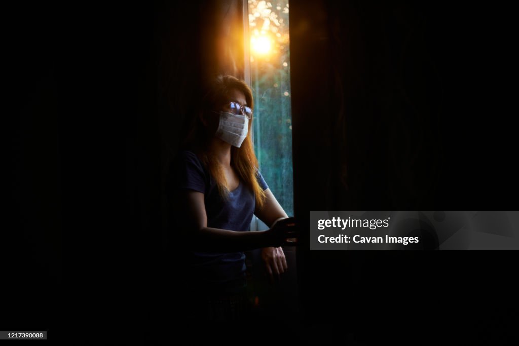 Reflection of woman in the mirror during stay home by COVID-19