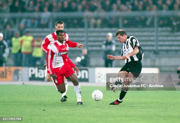 Zinedine Zidane of Juventus passes the ball under pressure from Martin Djetou of AS Monaco during the UEFA Champions League Semi-Final match between...