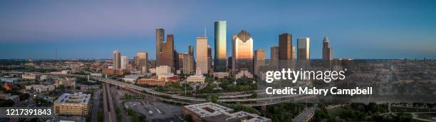downtown houston skyline at sunset panorama - houston stock pictures, royalty-free photos & images