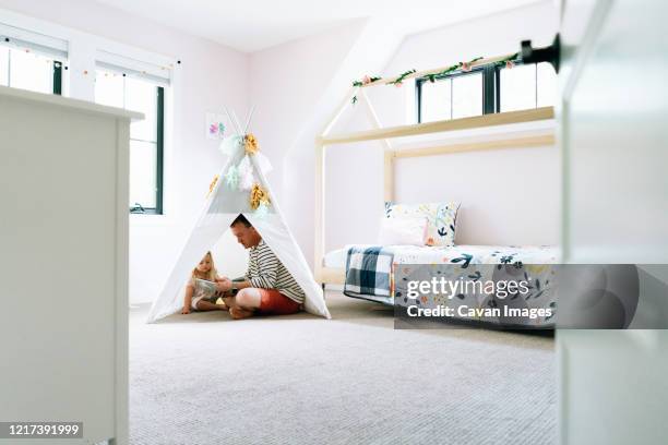 wide view of a father and daughter sitting together in a child's tipi - minneapolis house stock pictures, royalty-free photos & images