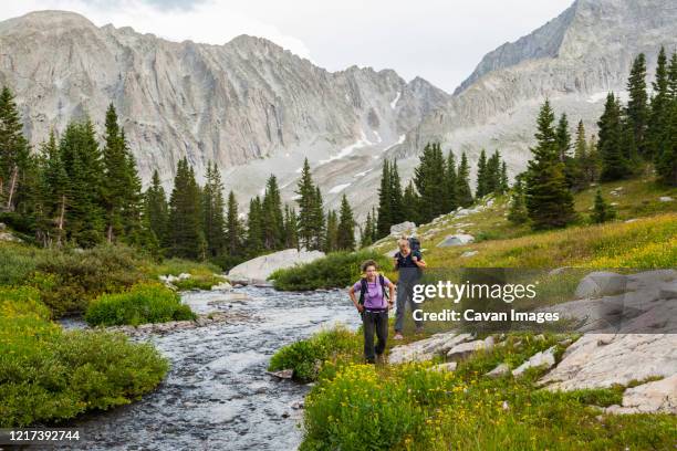 women hike up creek, meadow to pierre lakes, elk mountains, colorado - white river national forest fotografías e imágenes de stock