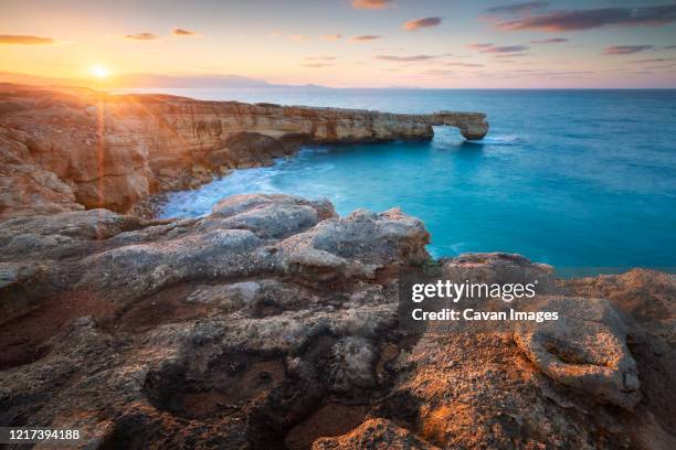 limestone cliffs and a rock arch near lavris village in rethymno regio - thessaloniki stock pictures, royalty-free photos & images