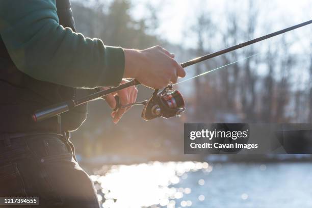 fishing on the lake at sunset. fishing background. - freshwater fishing stock photos et images de collection