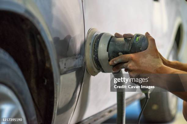 mechanic working in auto shop. - grinder stock-fotos und bilder