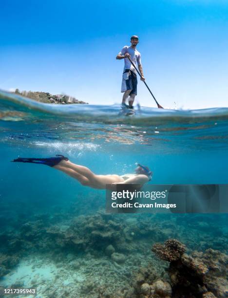 young couple have a fun in ocean water, underwater view - denpasar stock pictures, royalty-free photos & images