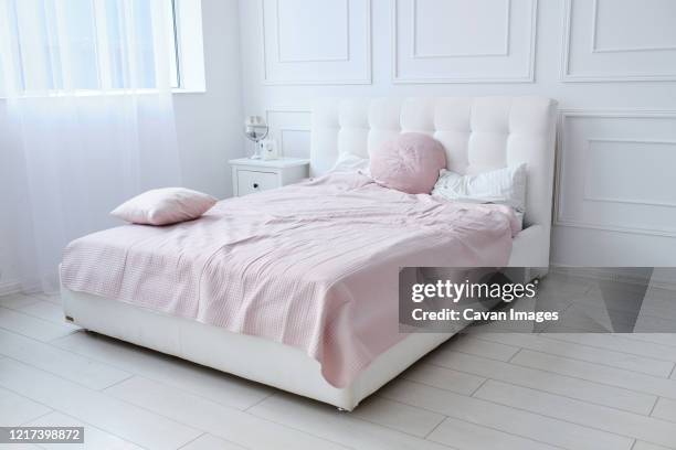 a large double bed in a bright room - skirting board stock pictures, royalty-free photos & images