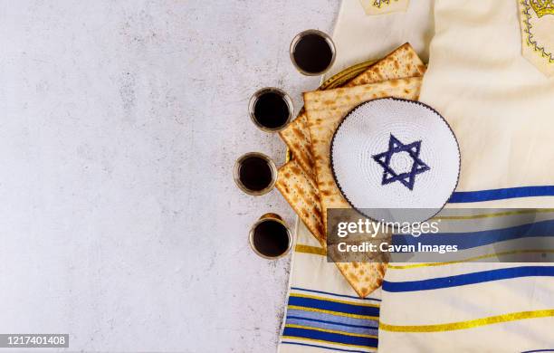 passover matzoh jewish holiday bread, four glasses kosher wine over table. - pesach seder stock pictures, royalty-free photos & images