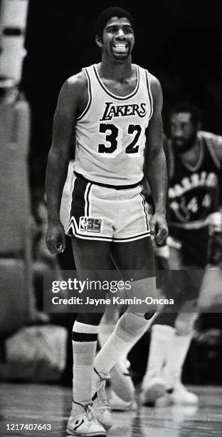 Magic Johnson of the Los Angeles Lakers walks on the court during a game against the San Antonio Spurs at The Forum, Los Angeles, California. NOTE TO...