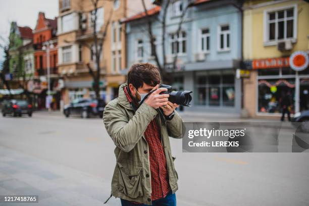 a reporter with a camera on the street - photojournalist stock pictures, royalty-free photos & images