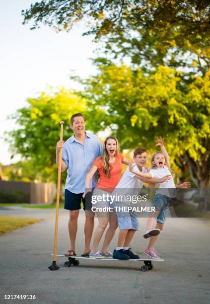 the whole family having fun - woman longboard stock pictures, royalty-free photos & images