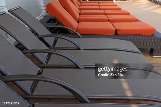 rows of outdoor recliner lounge chairs and cushions - spartan cruiser stock pictures, royalty-free photos & images