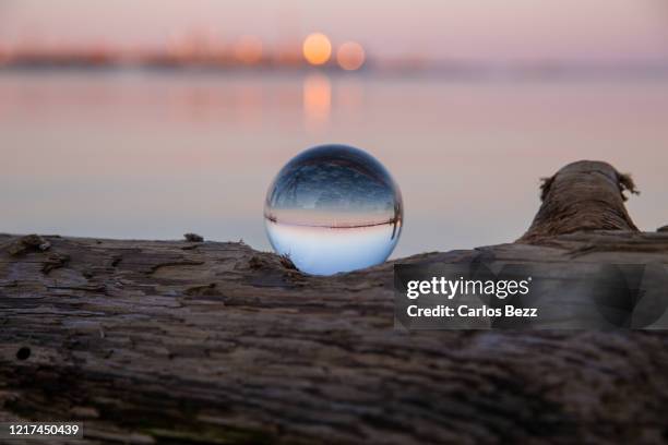 sunset over lake ontario with a lens ball - seen great lakes stock pictures, royalty-free photos & images