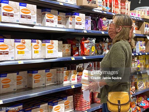 Woman wearing a mask shops for Passover items at a grocery store during the coronavirus pandemic on April 07, 2020 in Overland Park, Kansas. The...