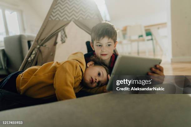 watching cartoons together - family with two children stock pictures, royalty-free photos & images