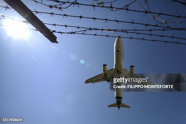 An Airbus A320 bearing the Alitalia livery lands at Rome's Fiumicino airport on June 3 as airports and borders reopen for tourists and residents free...