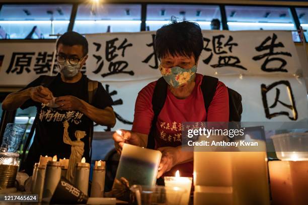 Pro-democracy activists takes part in a rally on the eve of Tiananmen Square Massacre candlelight vigil commemoration outside of the Lai Chi Kok...