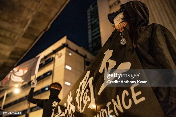 Pro-democracy activists take part in a rally on the eve of Tiananmen Square Massacre candlelight vigil commemoration outside of the Lai Chi Kok...