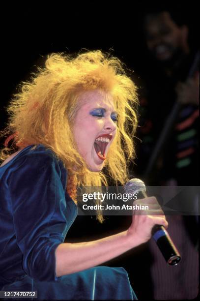 Singer, songwriter and actress Cyndi Lauper is shown performing on stage during a "live" concert appearance on December 20, 1986.