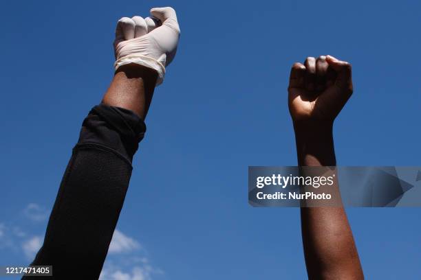 Activists gathered in protest at the killing of George Floyd raise fists outside the US embassy in London, England, on May 31, 2020. Thousands came...
