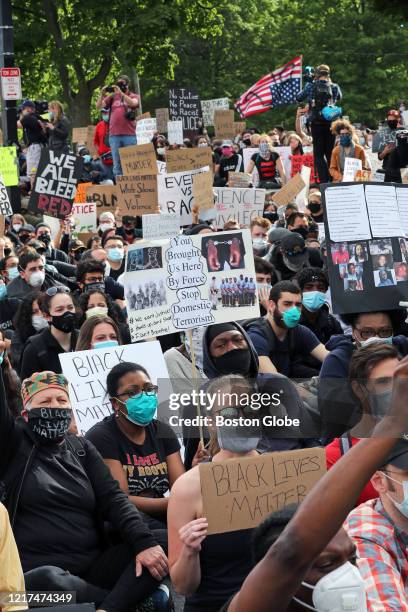 Activists participate in a "die-in" for 8 minutes and 46 seconds, the exact time that George Floyd was pinned to the ground, during a rally, vigil...