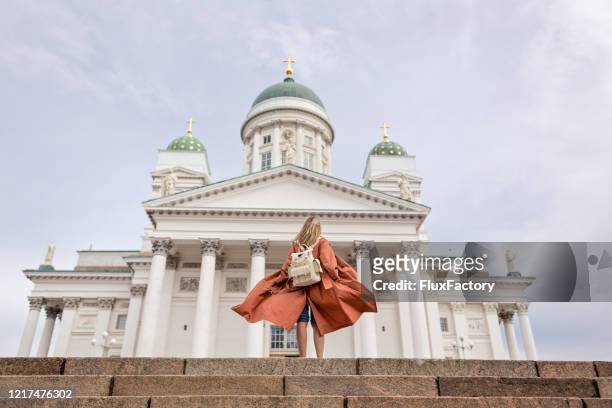 fashionable woman visiting a helsinki cathedral while traveling - helsinki stock pictures, royalty-free photos & images