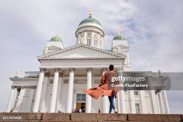 fashionable woman looking at a helsinki cathedral - helsinki stock pictures, royalty-free photos & images