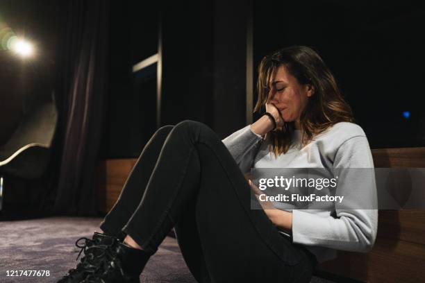 crying woman sitting in a hotel room alone - photos of suicide victims stock pictures, royalty-free photos & images
