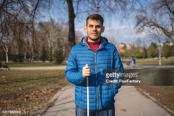 independent young blind person with a walking cane - blind man stock pictures, royalty-free photos & images