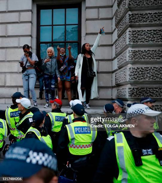 Protestors gestures towards Police officers in Parliament Square, during an anti-racism demonstration in London, on June 3 after George Floyd, an...